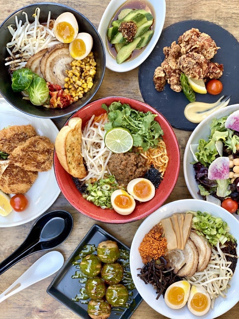 Plates and bowls full of various menu items.