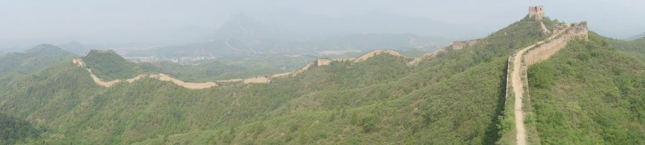 Panoramic view of the Great Wall of China in smoggy air.