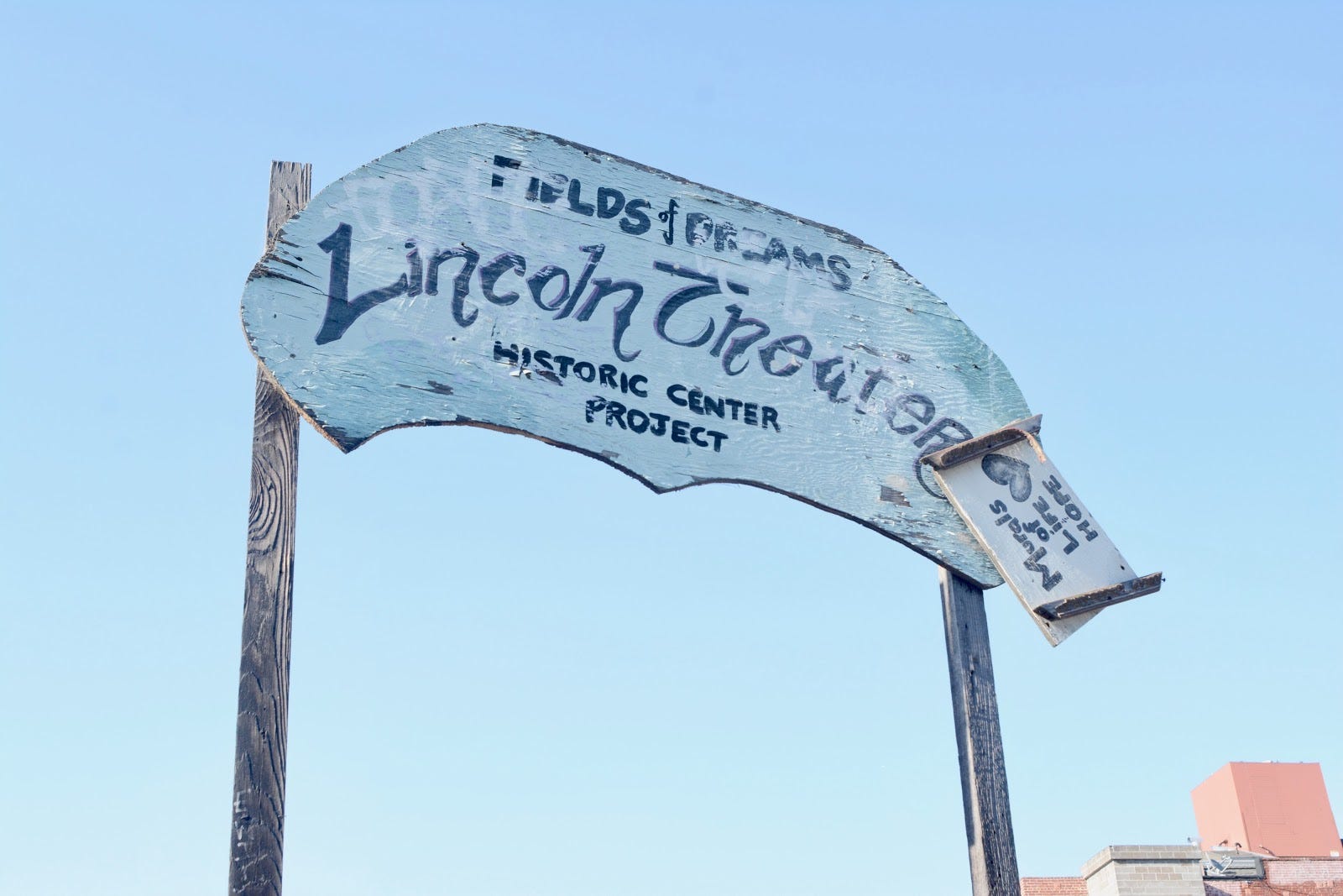 Dilapidated sign saying “Field of Dreams: Lincoln Theater Historic Center Project.”
