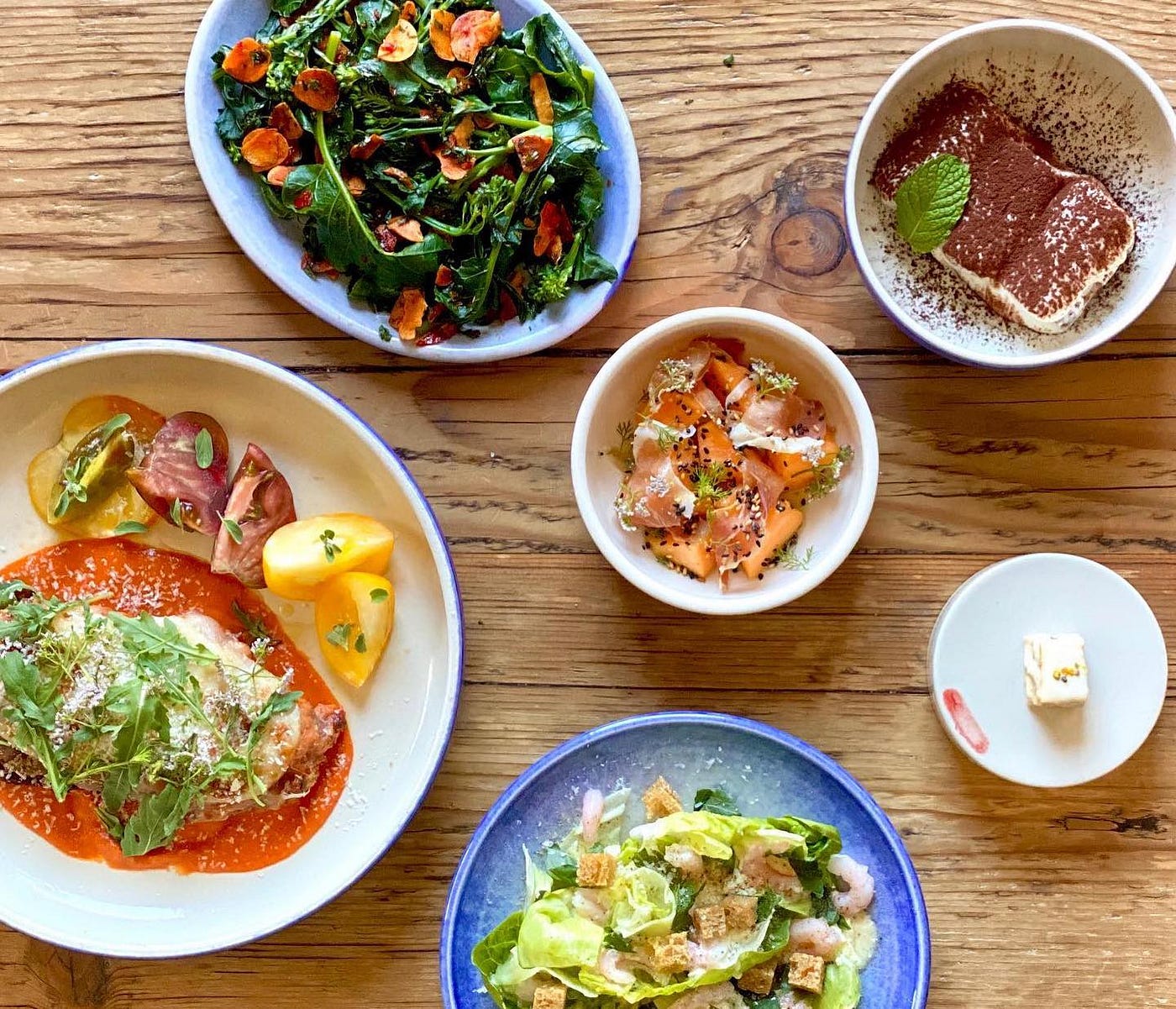 Dishes on plates and bowls of various sizes.