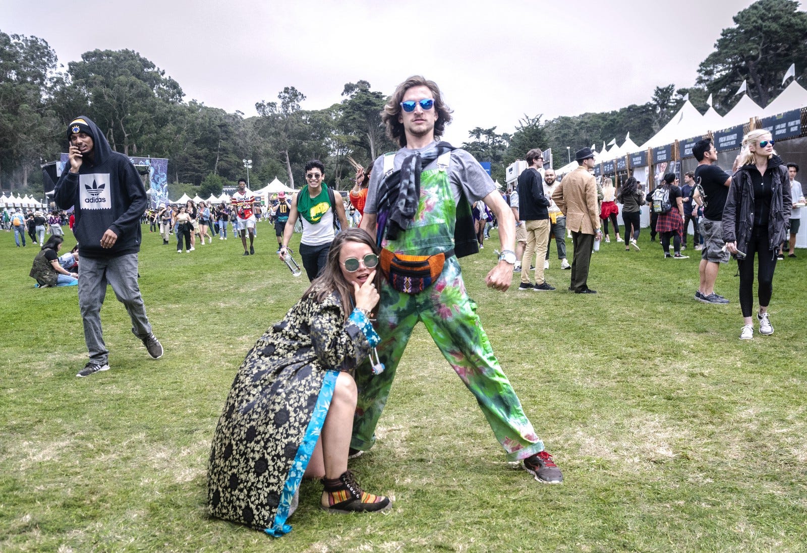 Two festival-goers posing at an outdoor festival.