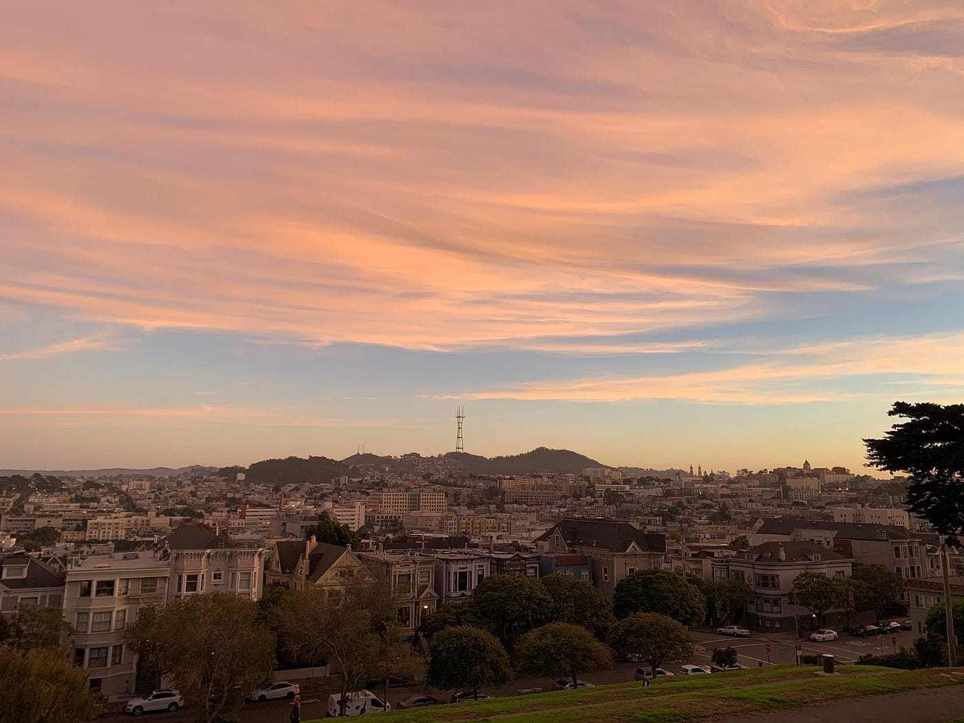 A view of San Francisco with the Sutro Tower in the background, taken around sunset.