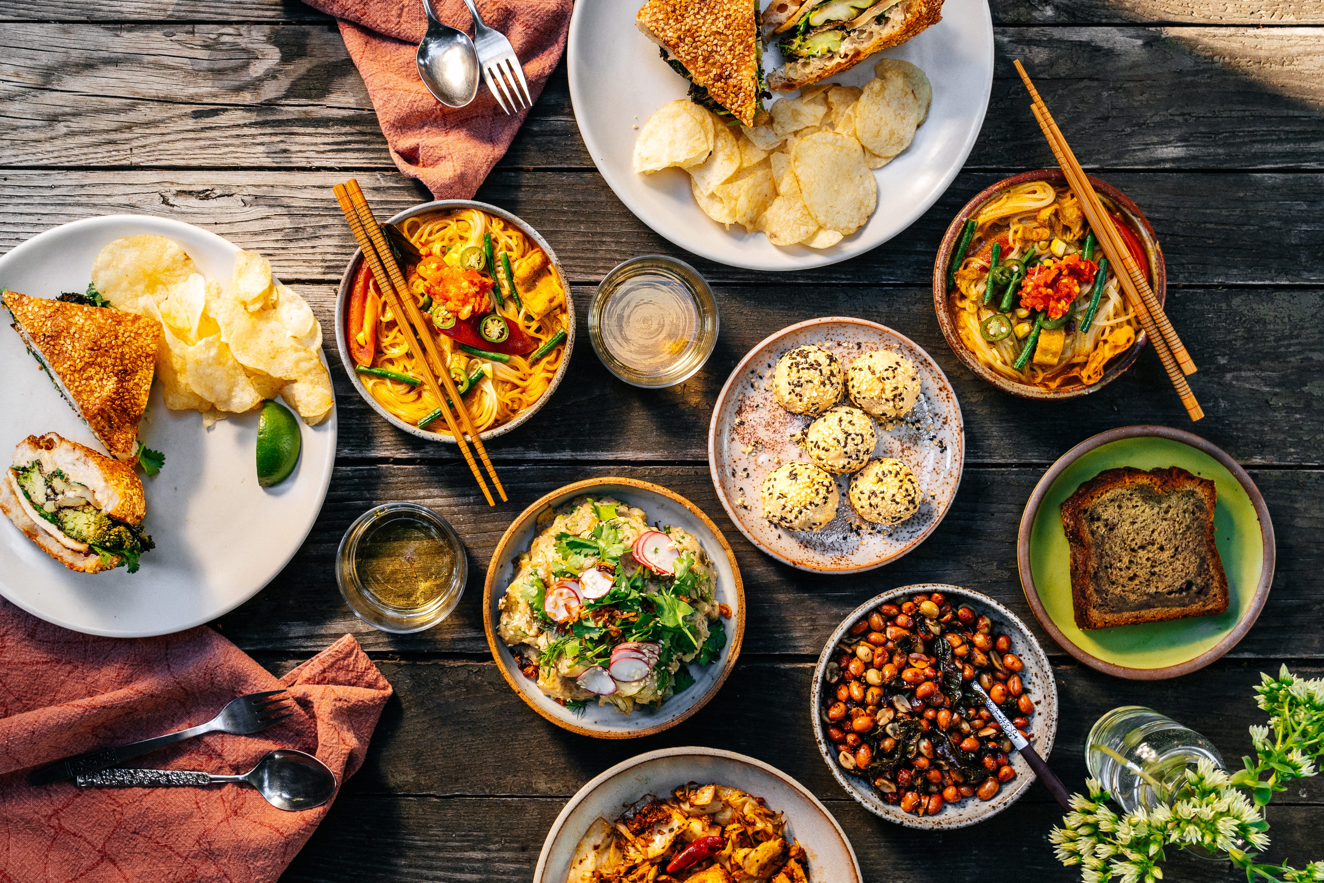 Overhead view of many dishes on differently sized and colored plates.