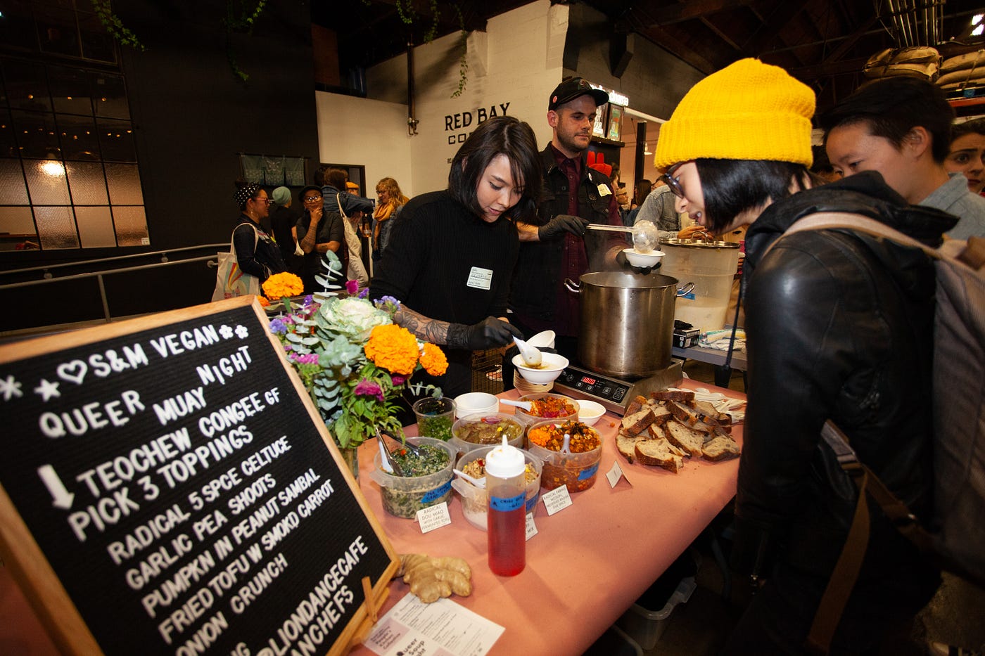 People studying the menu while employees cook.