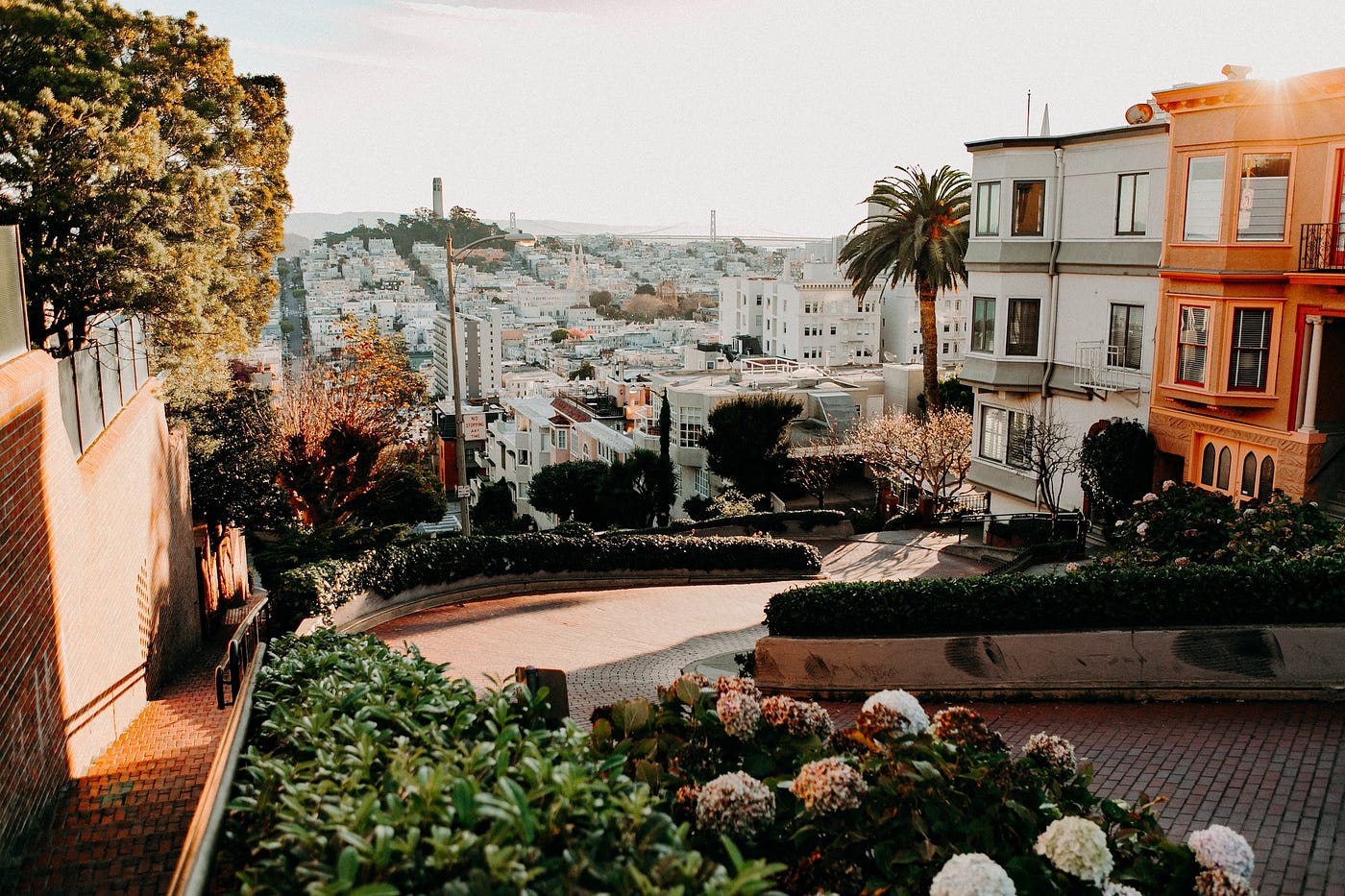 View of the city with Lombard Street in the foreground, as seen from the top of the hill Lombard winds down.