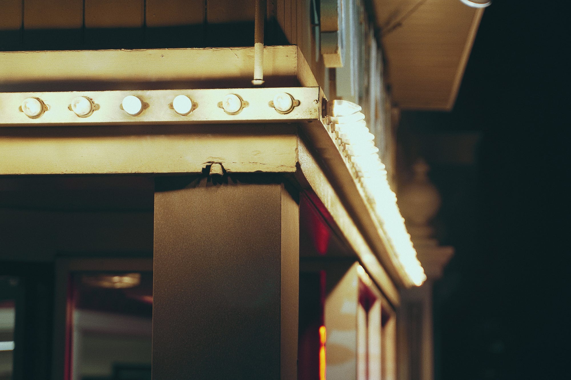 Closeup of small light bulbs decorating a window.
