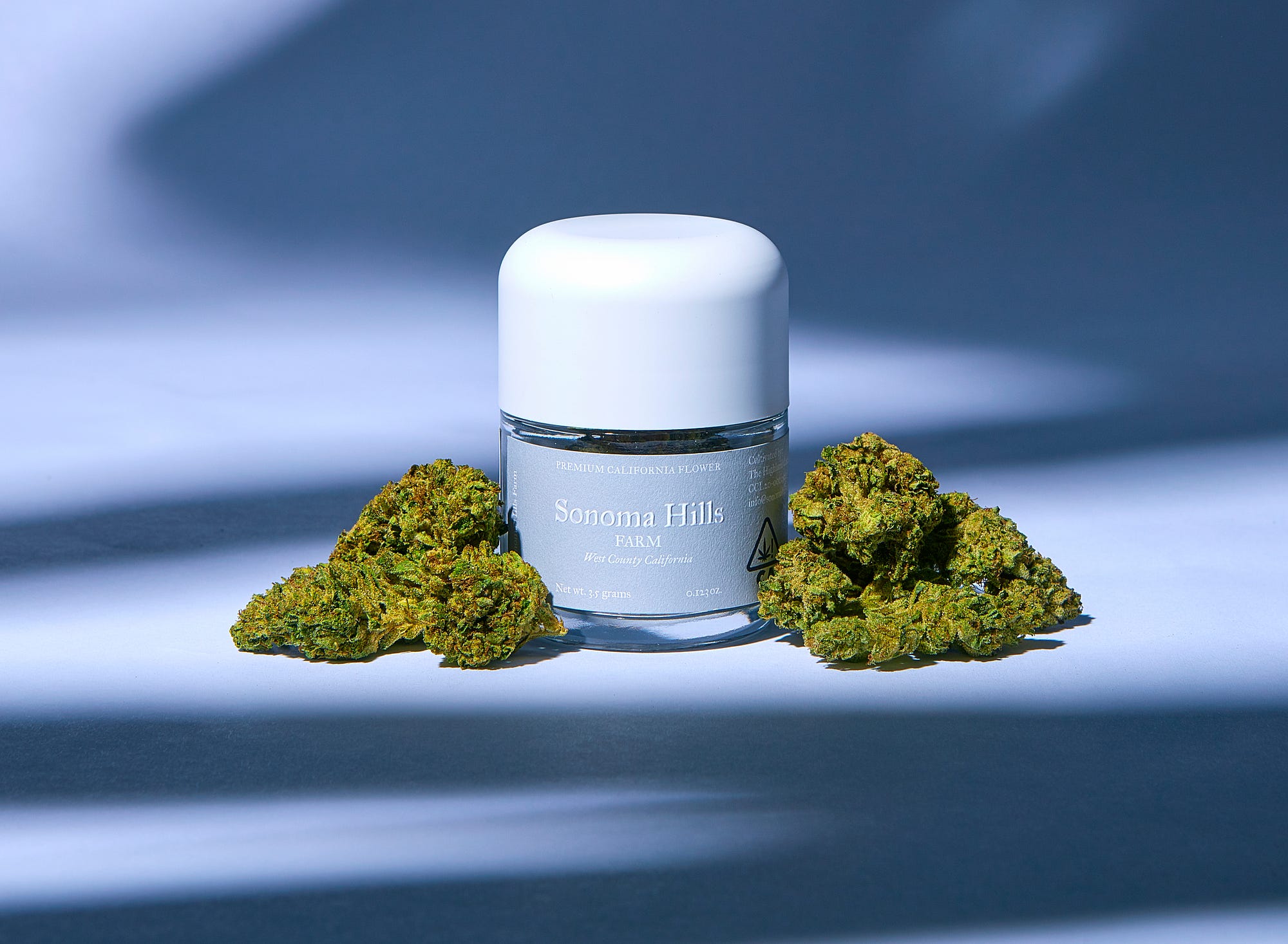 Jar with Sonoma Hills label on it with nugs of flower on either side.