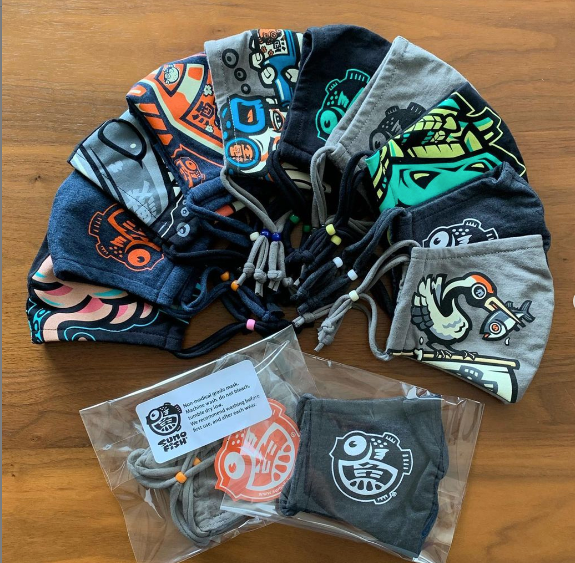 An assortment of masks with different colorful illustrations, arranged in a semicircle.