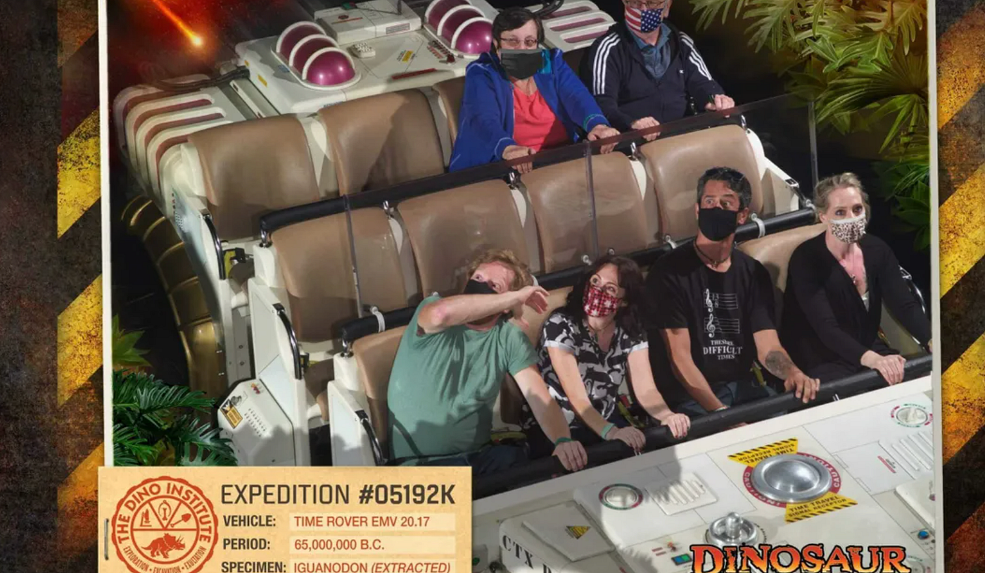 A photo card of people “wearing” digitally added masks on the Dinosaur ride.