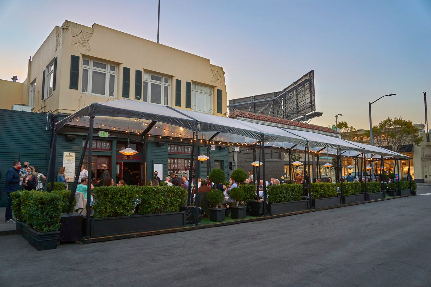 The exterior of Izzy’s, with socially distanced dining booths.