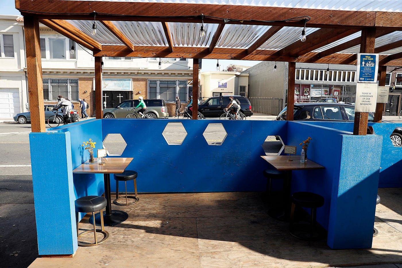 An outdoor dining cubicle with a clear roof.