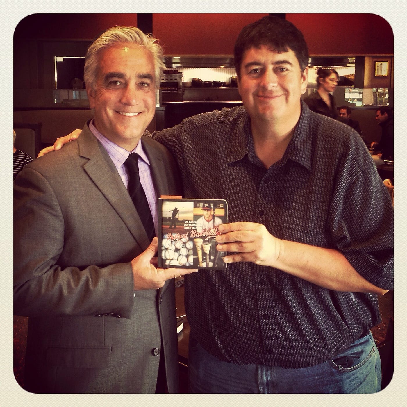 Pedro and Brad hold up a copy of Brad’s book of Instagram pictures of baseball players.