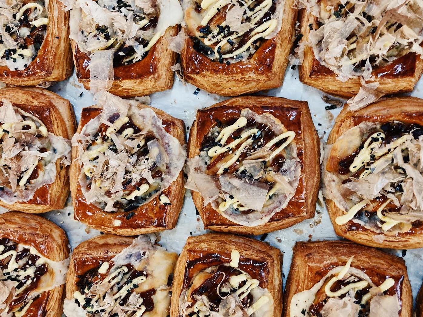Rows of sticky buns on a baking sheet.